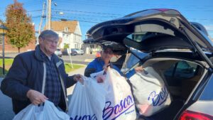 Mike DeFeo and Frank start loading the cars for delivery.