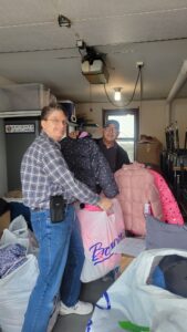 Frank, Patty (taking photo), and Randy sorted and arranged the 188 coats.